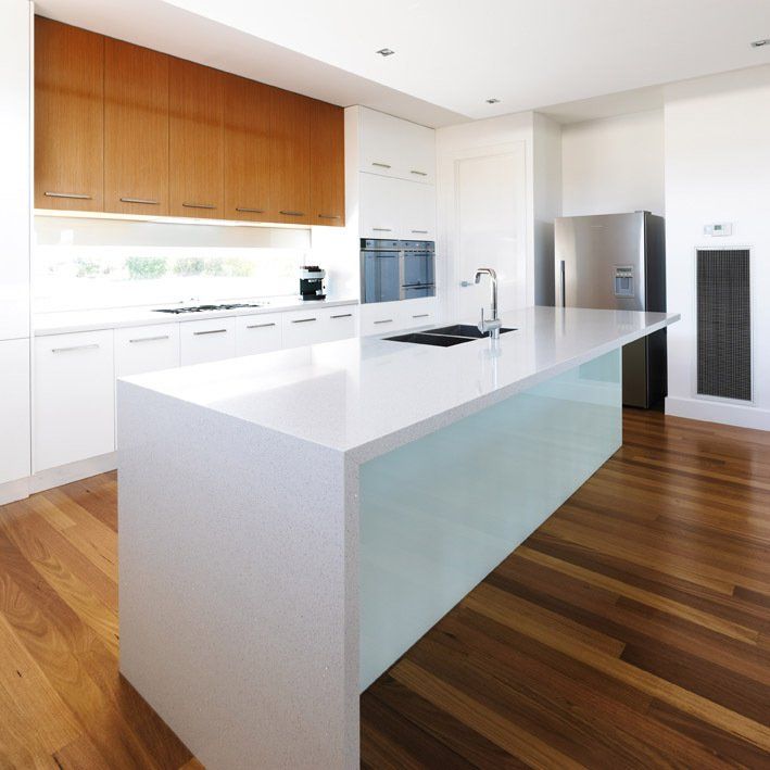 White colour tough quartz surface installed by experts in the kitchen of the customer