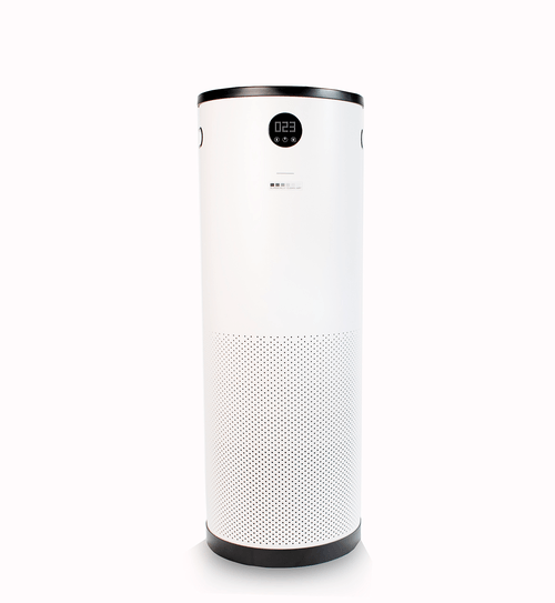 A white air purifier is sitting on a white surface.