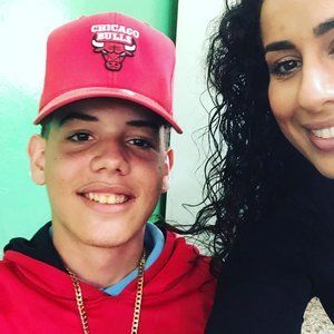 A man wearing a red chicago bulls hat smiles next to a woman