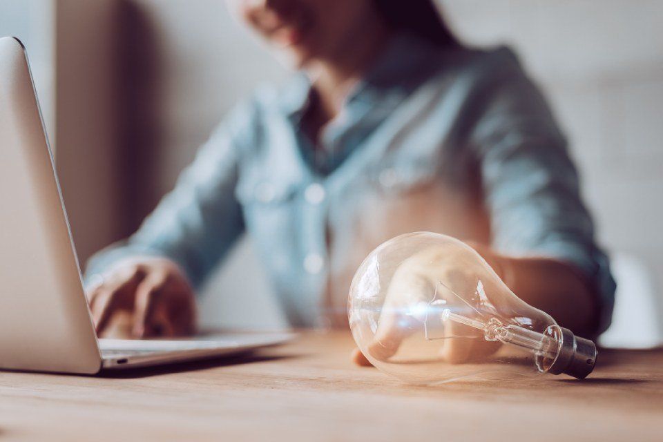 person sitting next to a light bulb
