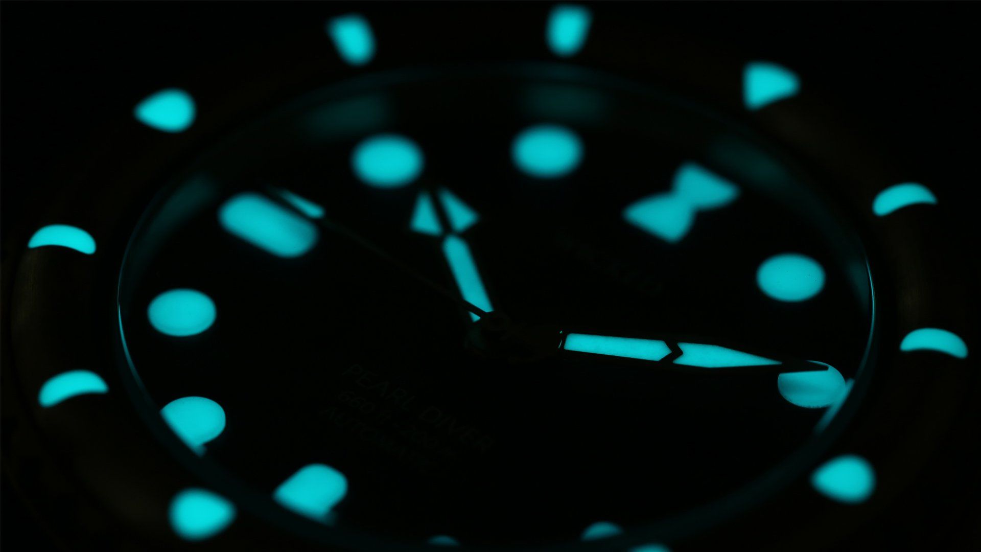 A close up of a glow in the dark watch face.