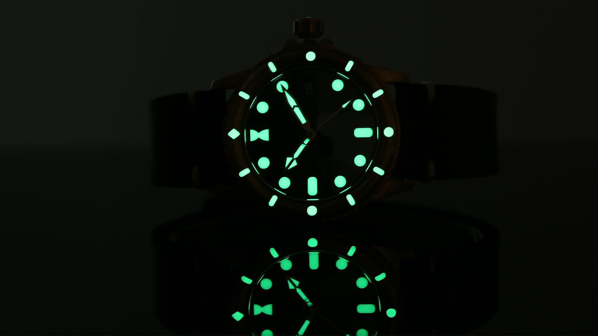 A close up of a glow in the dark watch face