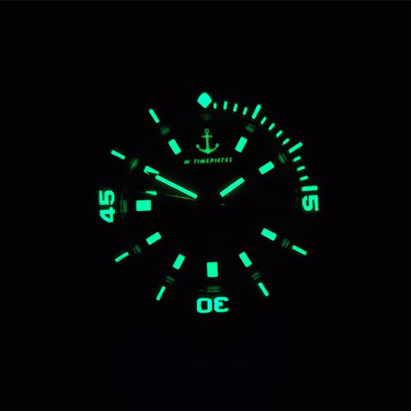Glow in the dark face of a watch that says timemaster