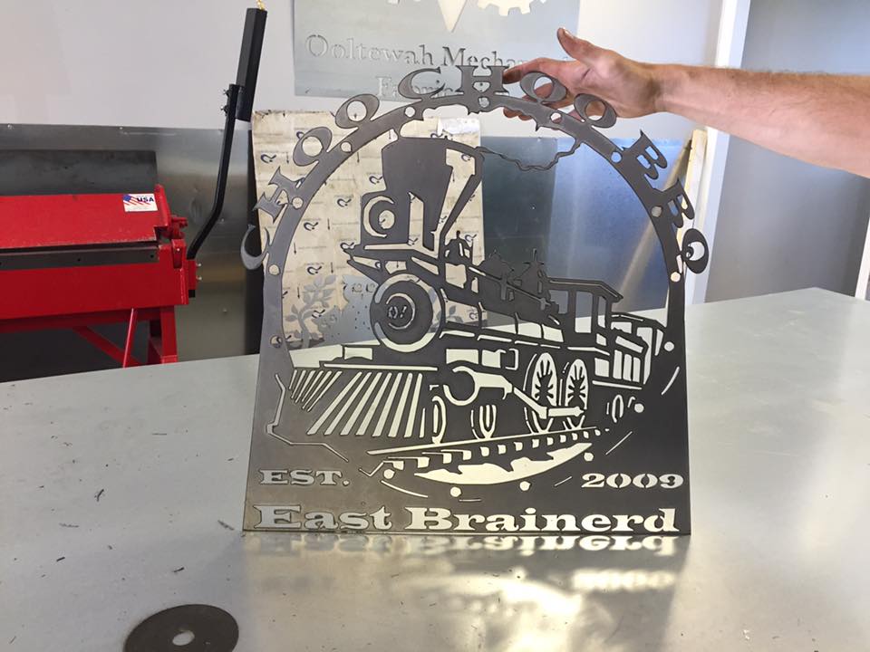 A person is holding a sign that says east brainerd