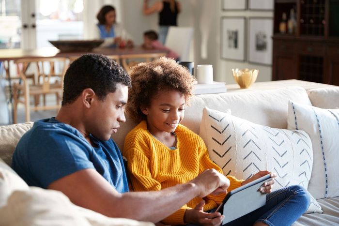 family sitting on couch photo