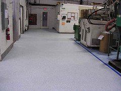 a hallway in a factory with a machine on the floor .