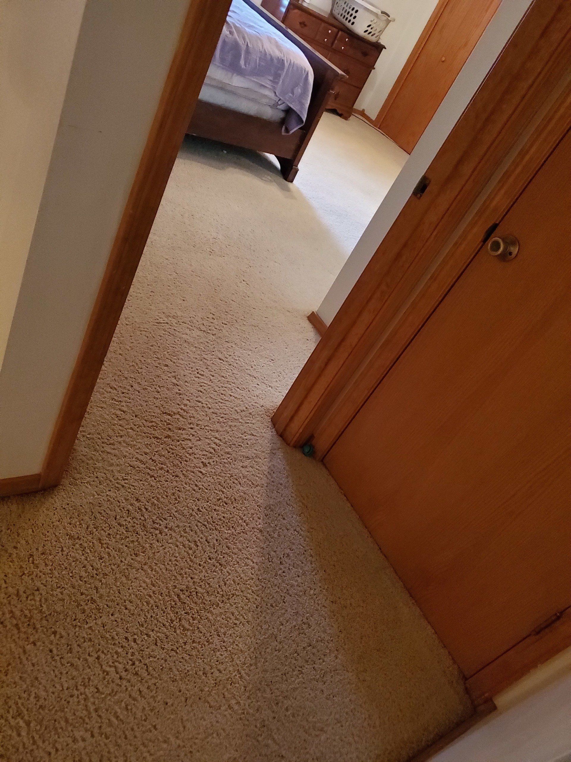 A bedroom with a bed and a doorway leading to it