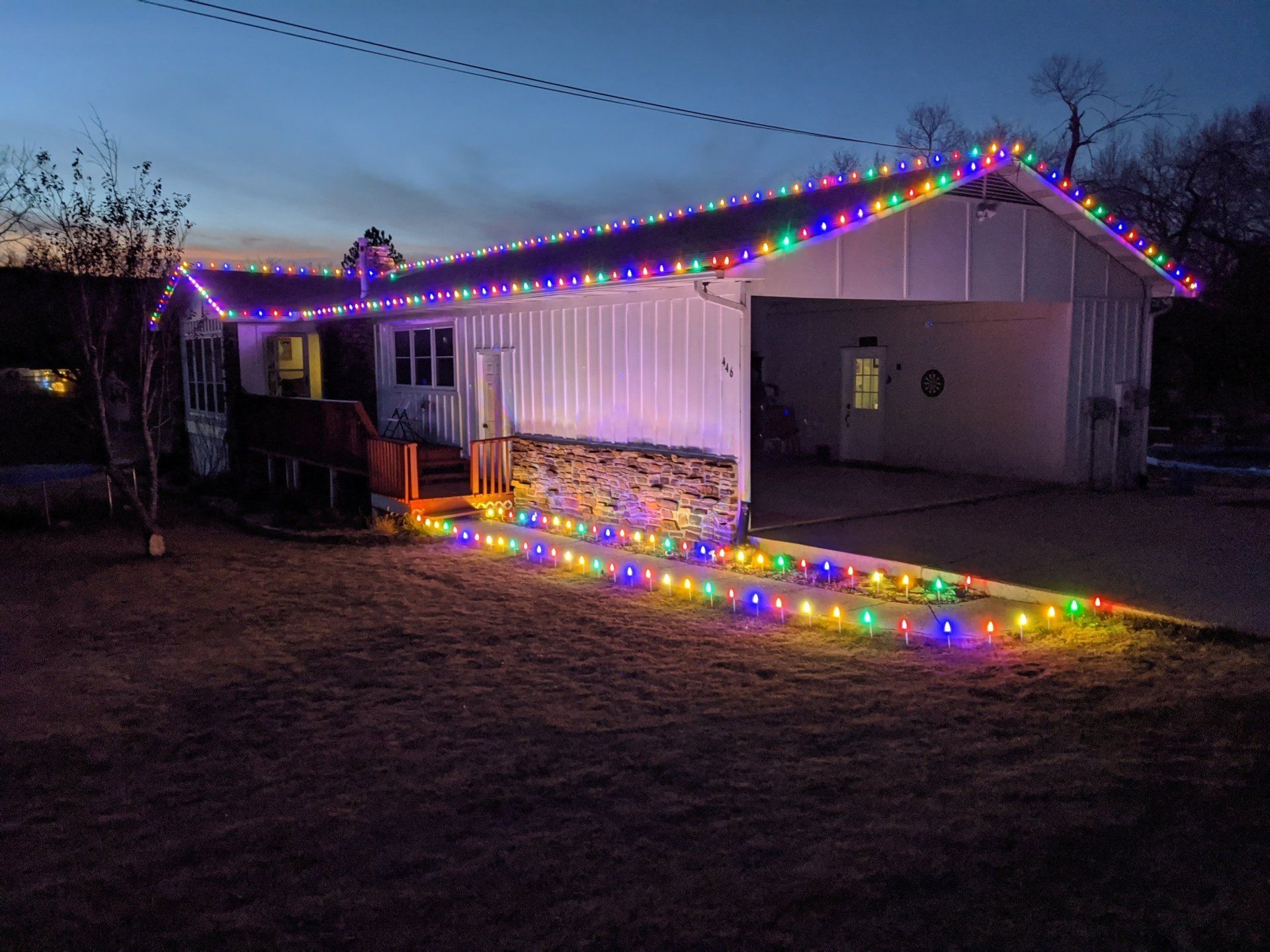 A house is decorated with christmas lights at night.