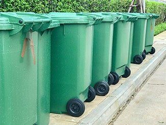 Row of green plastic bin - Waste Management in Somerset County, NJ