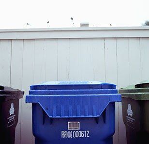 Recycling bins against white wall - Waste Management in Somerset County, NJ Recycling bins against white wall - Waste Management in Somerset County, NJ