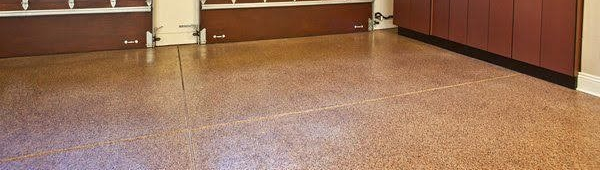 Empty banquet hall with brown wood-paneled walls and a speckled tile floor