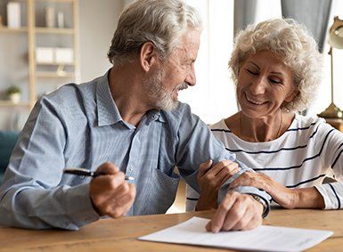 Elderly Couple Signing Documents — Bronx, NY — The Law Office of Patrick J. Wynne Elderly Couple Signing Documents — Bronx, NY — The Law Office of Patrick J. Wynne