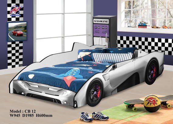 Silver race car bed in a child's room with racing décor; skateboard nearby.