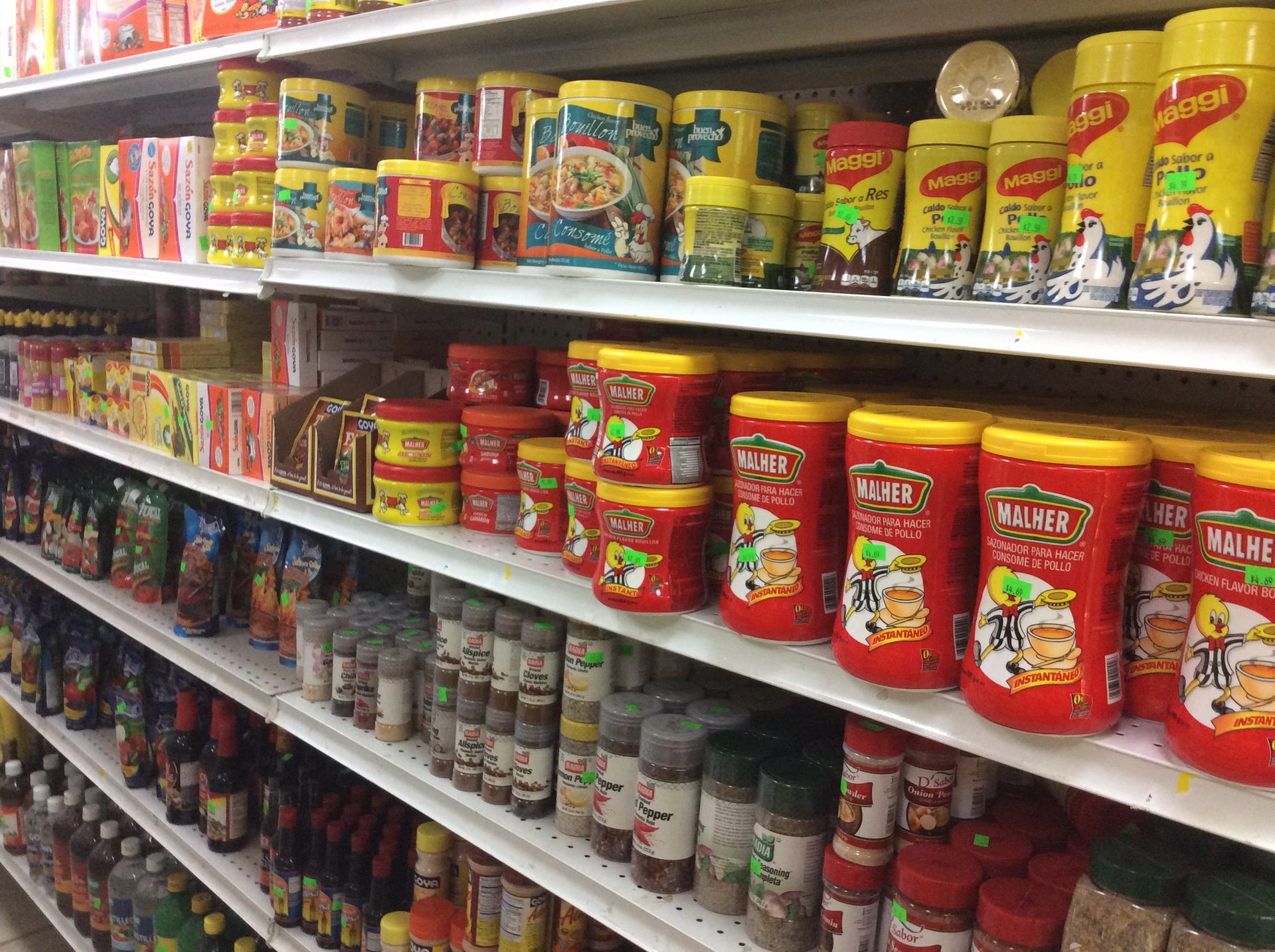 Shelves stocked with various canned and jarred food products in a grocery store.