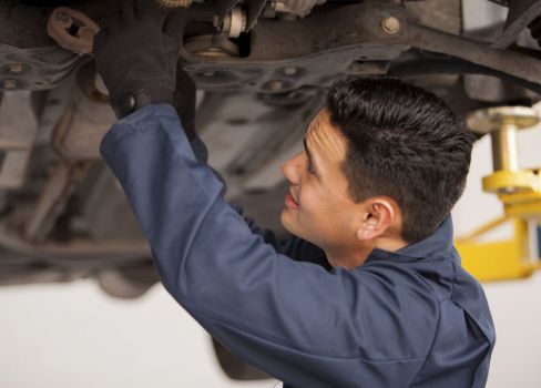 mechanic doing repair under the car