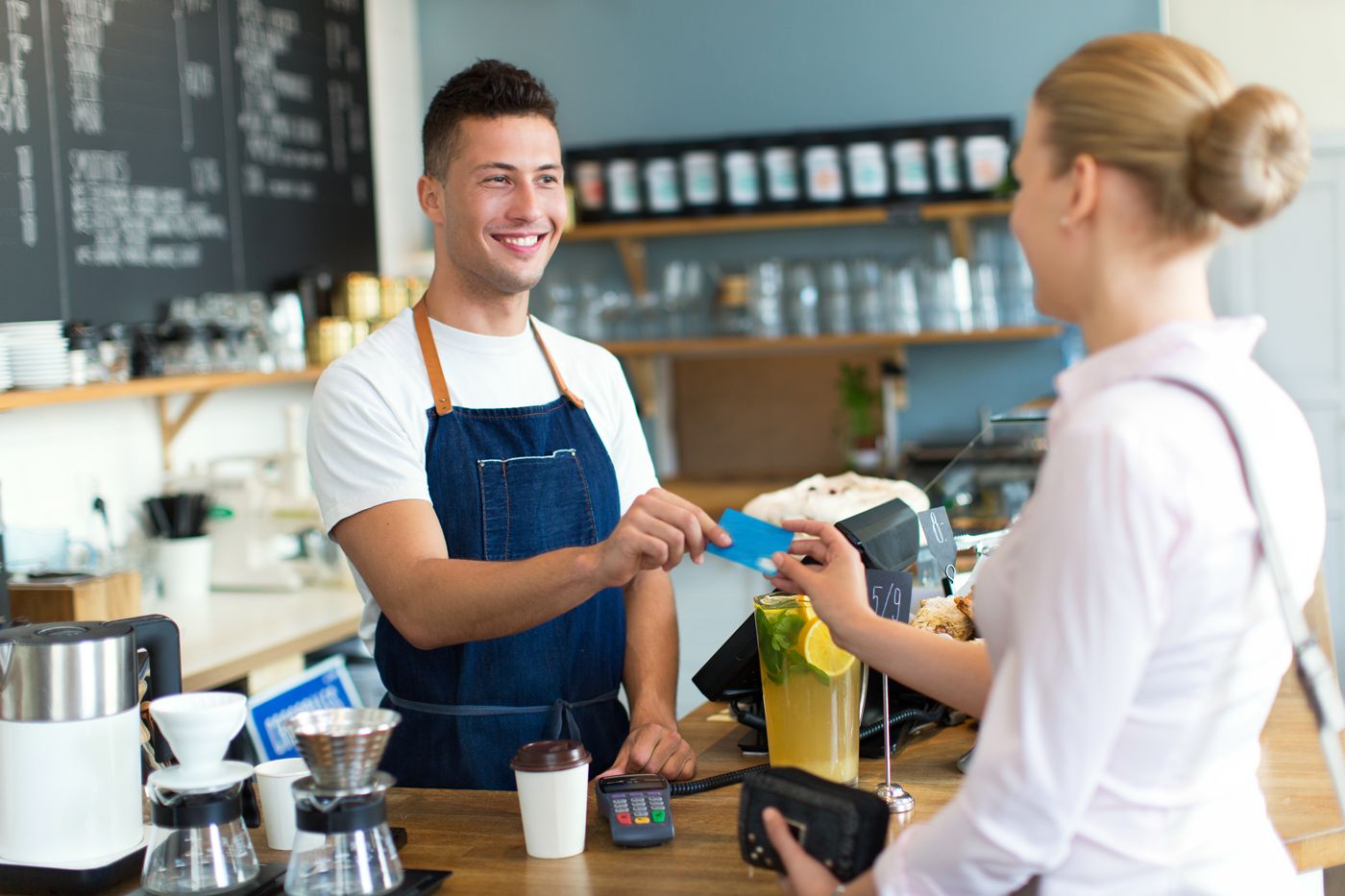 Woman paying through pos at store