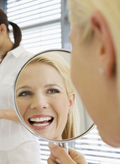 A lady happy after seeing a family dentist in Busselton