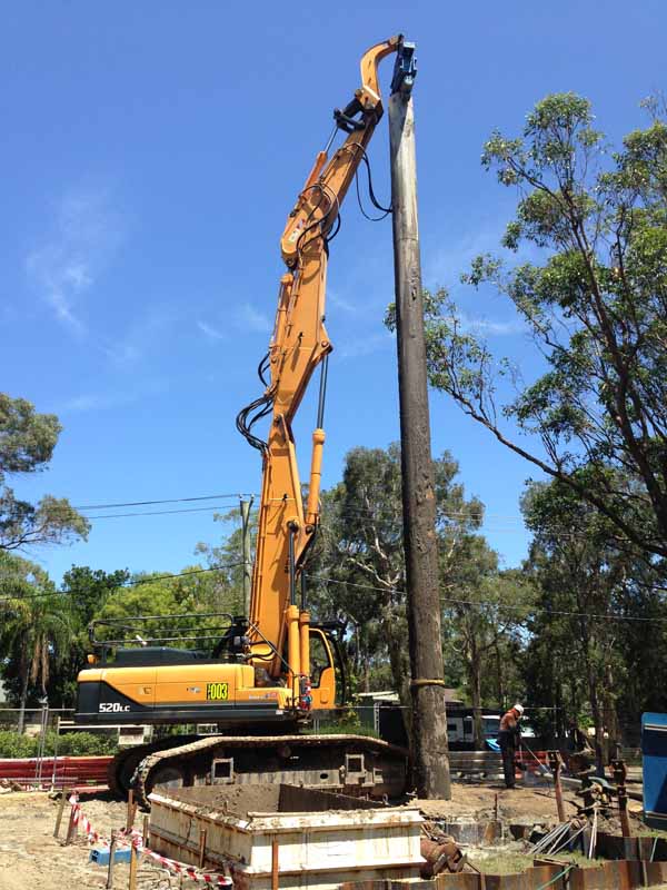 yellow sheet piling excavator