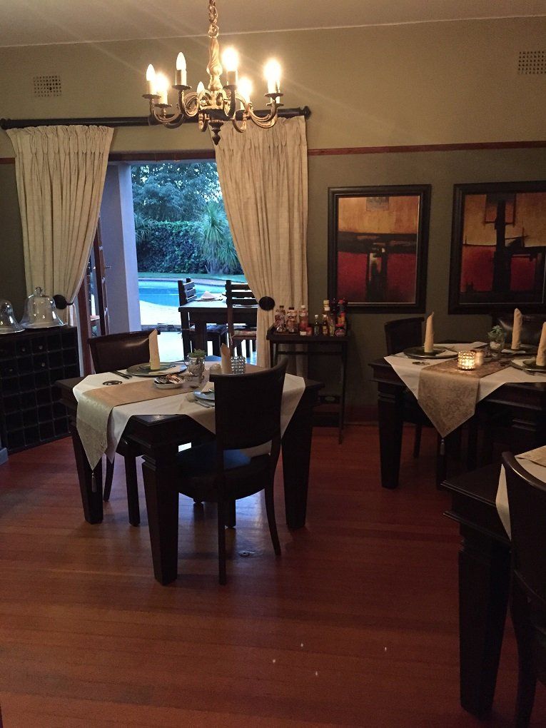 A dining room with tables and chairs and a chandelier