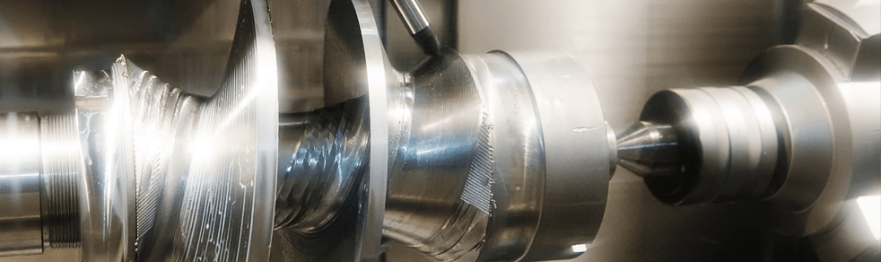 A close up of a metal machine in a factory.