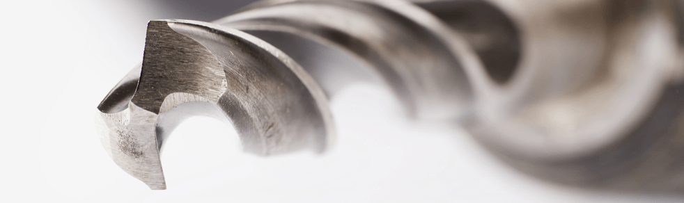 A close up of a drill bit on a white background.