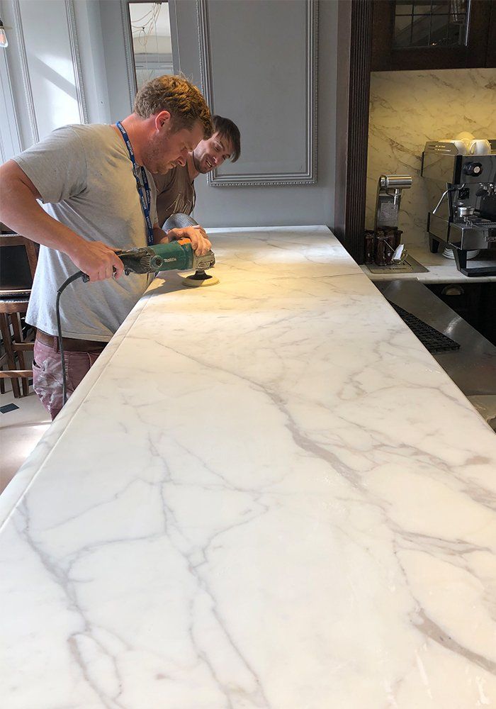 men polishing marble kitchen top