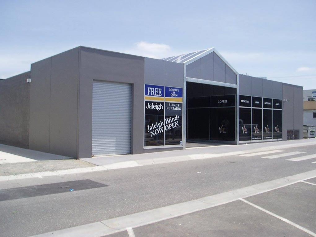 a short commercial building with large windows