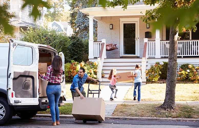 Family unloading moving van.