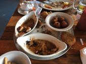 A table topped with plates of food and bowls of food.