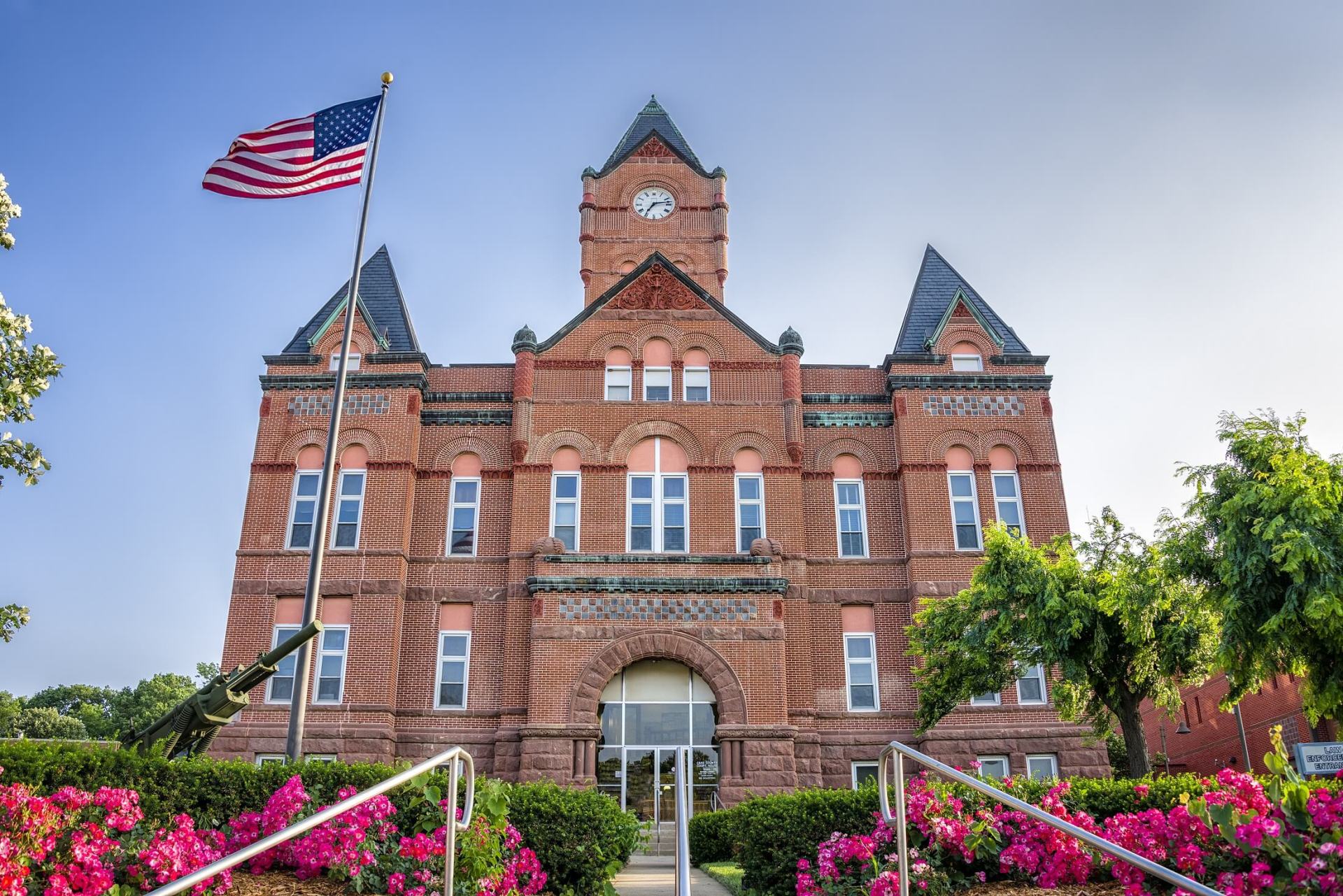A large brick building with an american flag flying in front of it