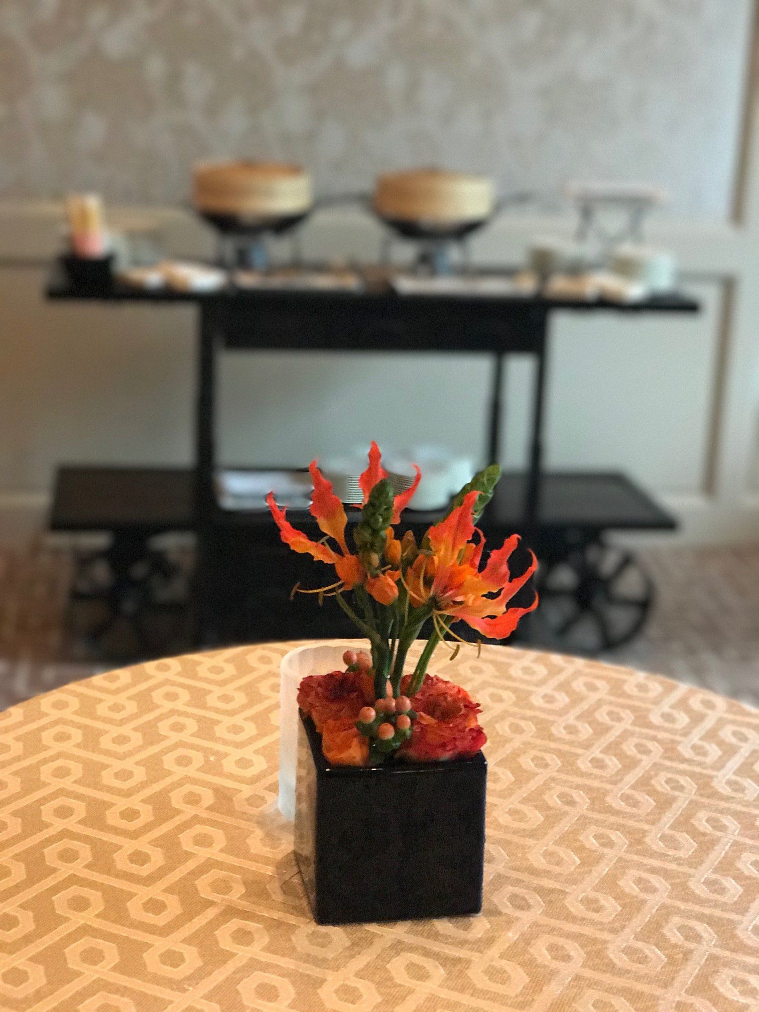 A table with a vase of flowers on it