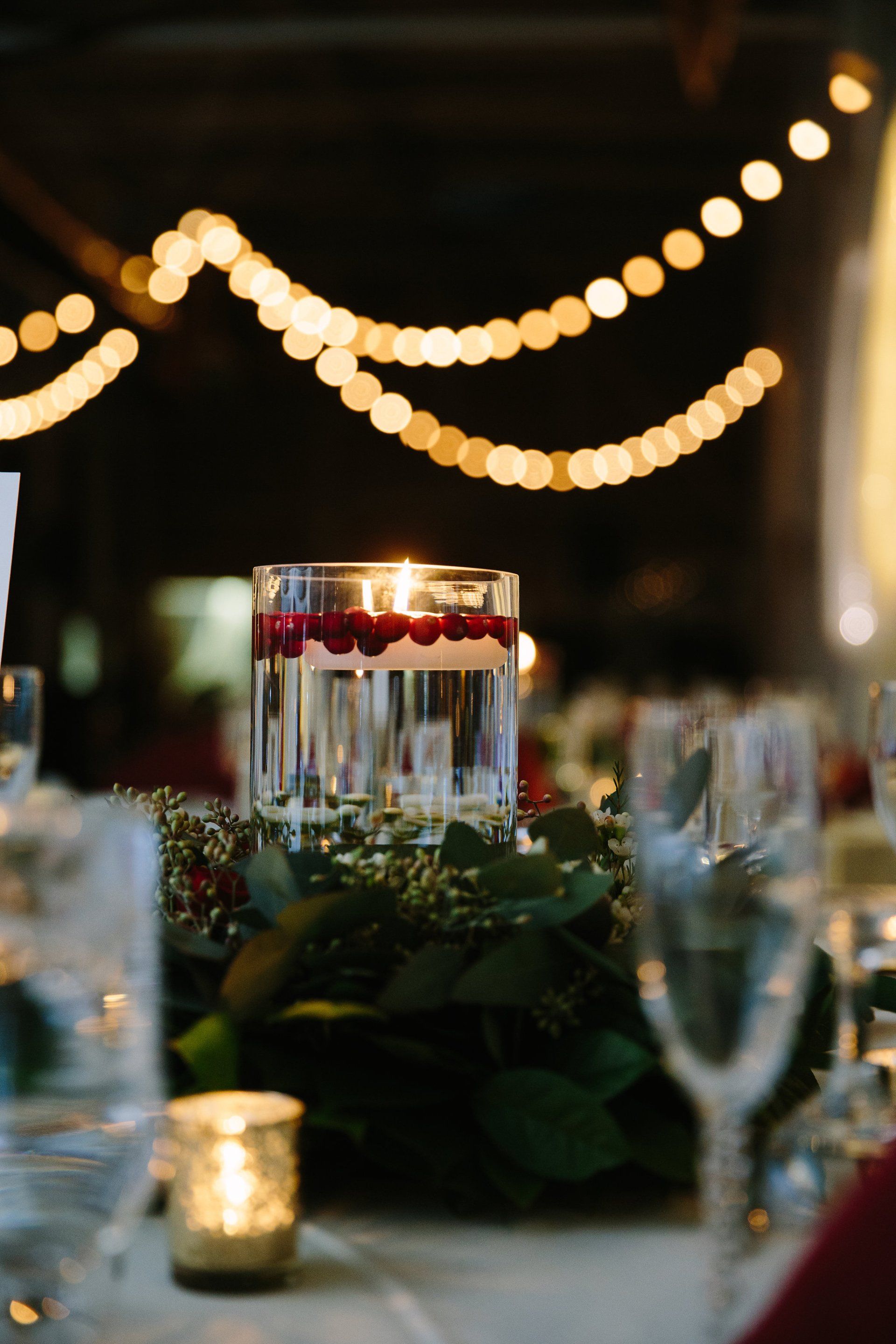 There is a candle in a glass on the table.