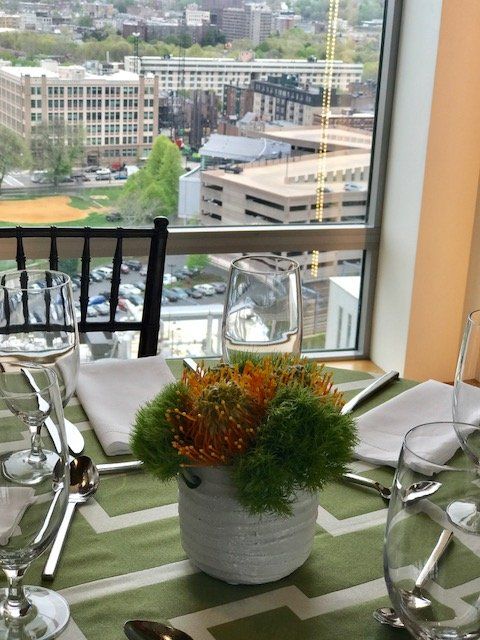 A table setting with a vase of flowers on it