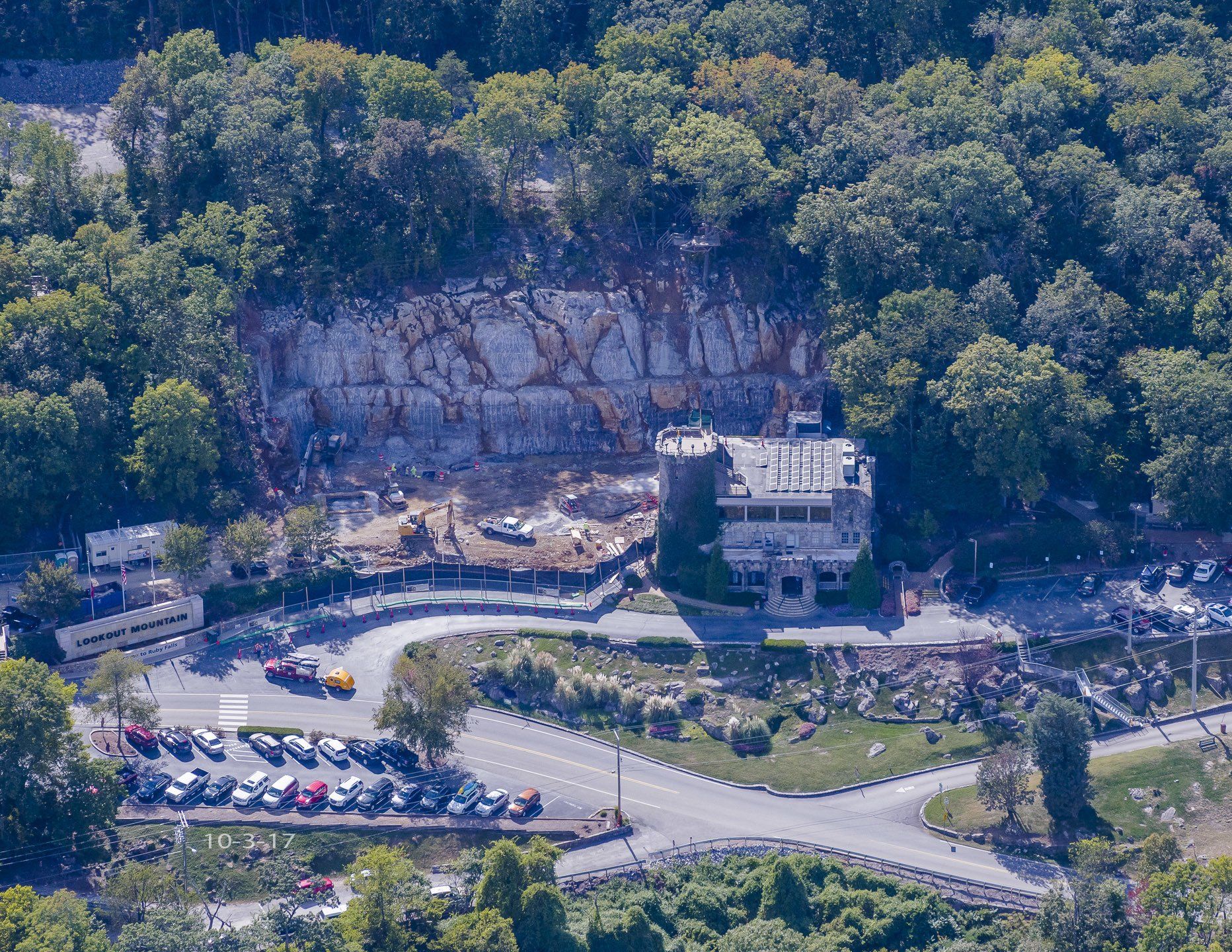 An aerial view of a building in the middle of a forest