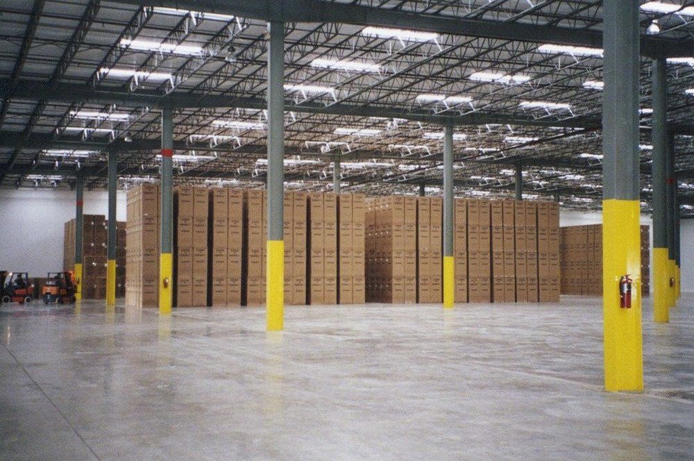 A large warehouse filled with lots of cardboard boxes