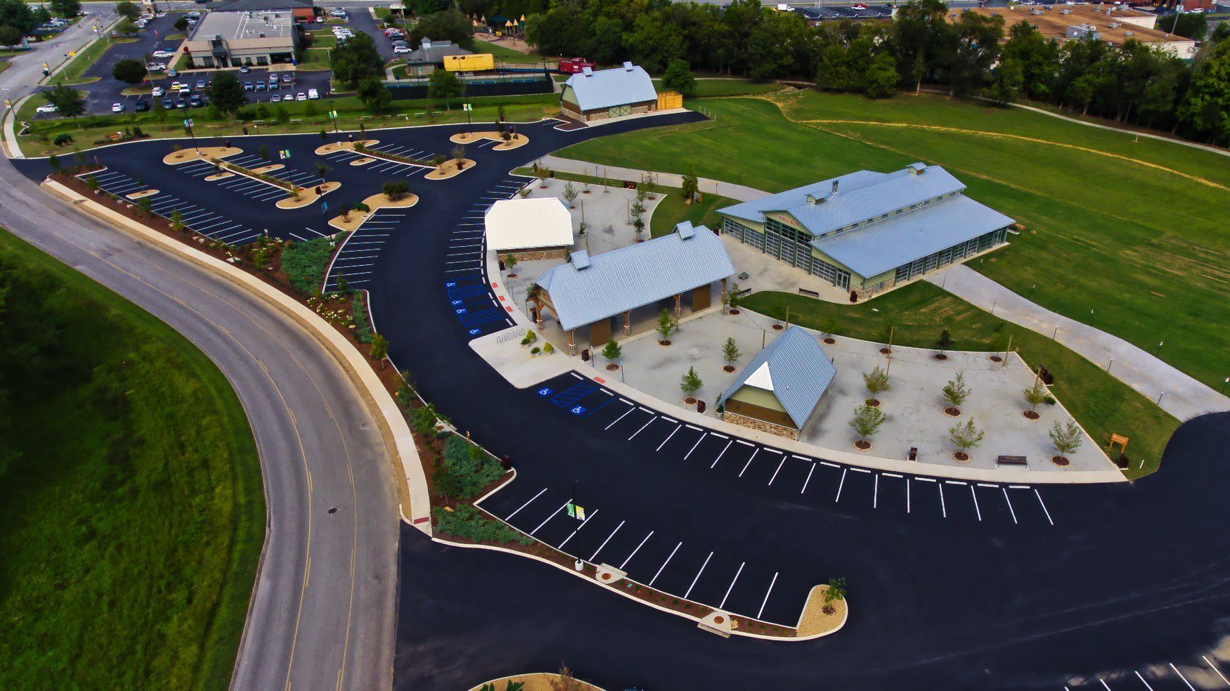 An aerial view of a parking lot next to a road