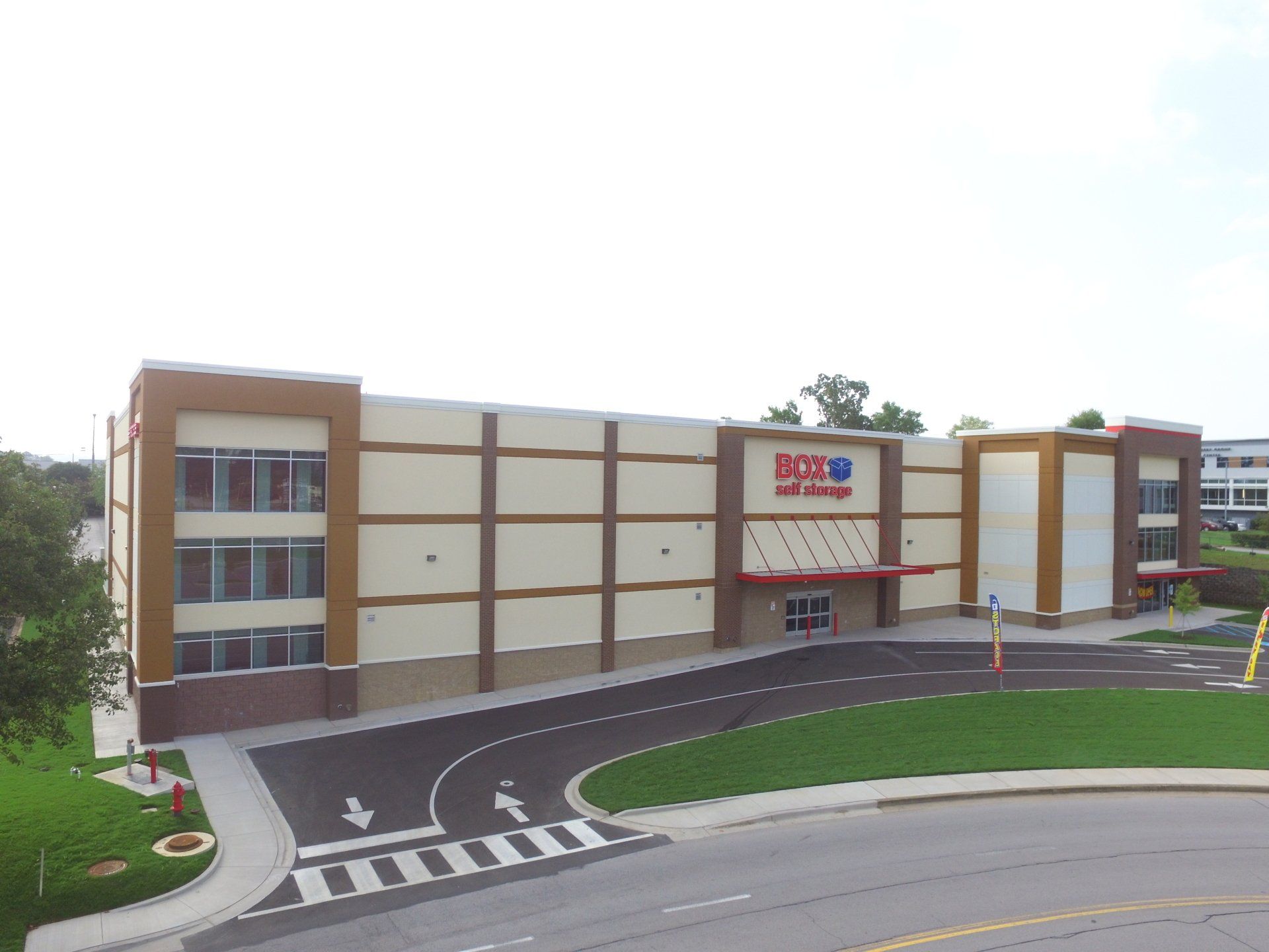 An aerial view of a large building with a parking lot in front of it.