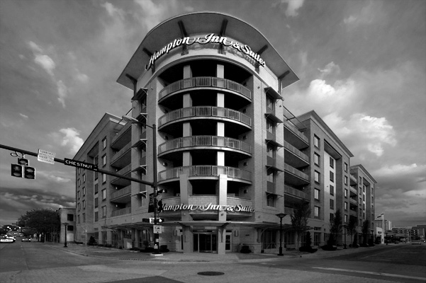A black and white photo of a large apartment building