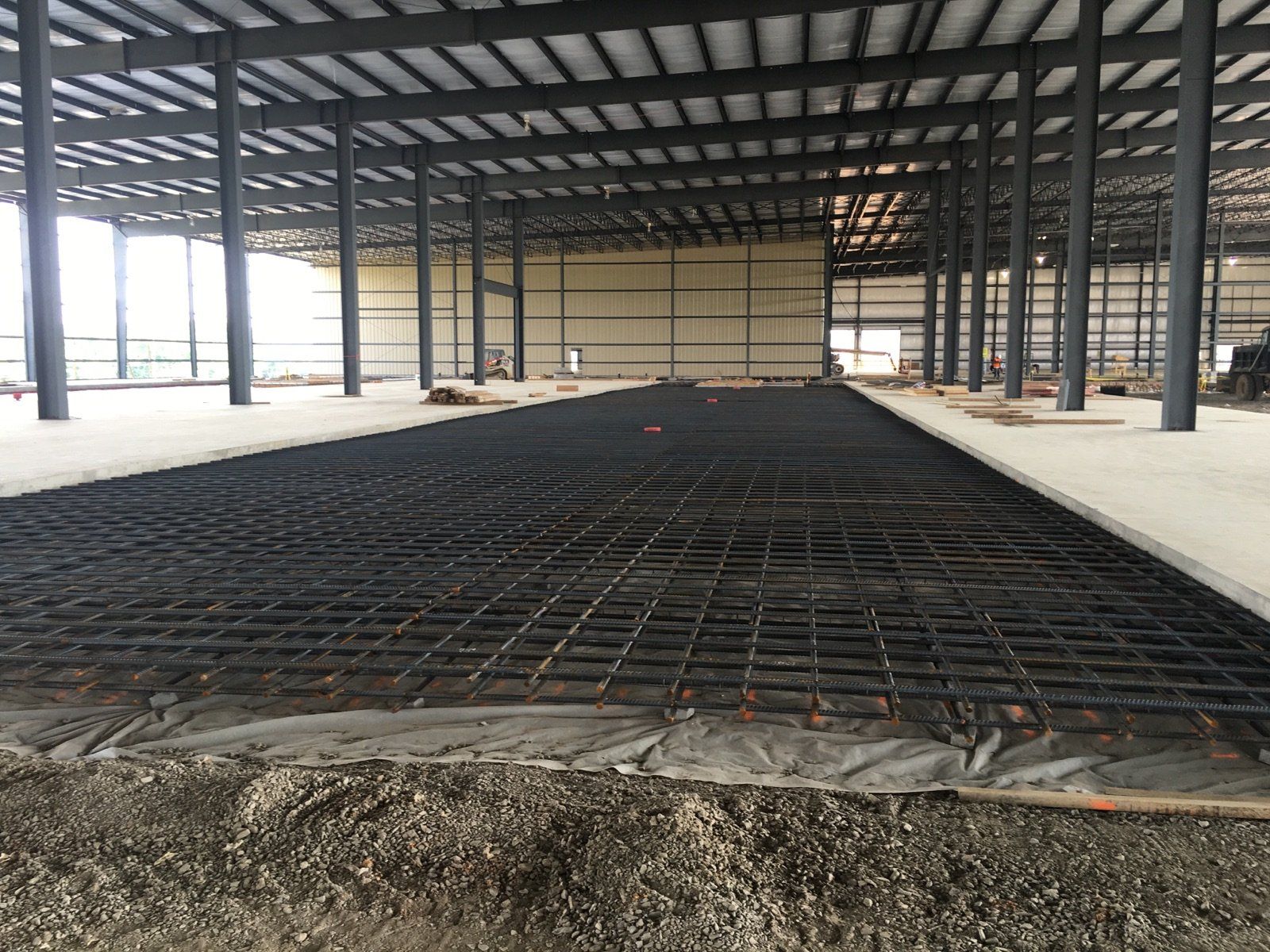A large building under construction with a concrete floor.