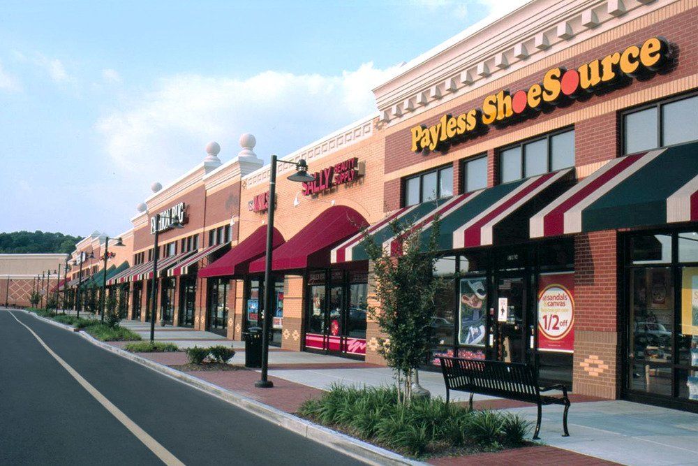 A row of payless shoesource stores along a street
