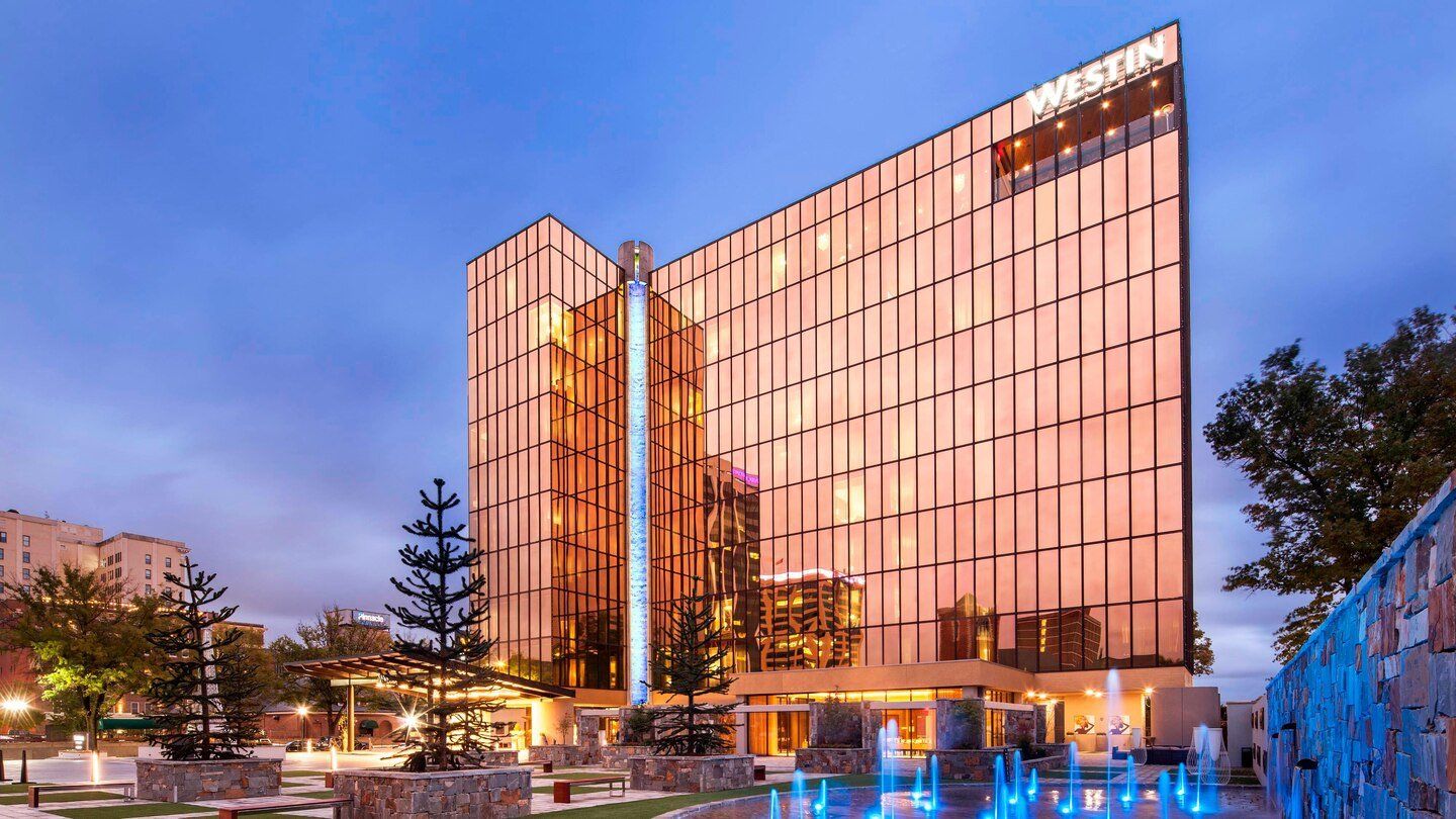 A large building with a fountain in front of it.