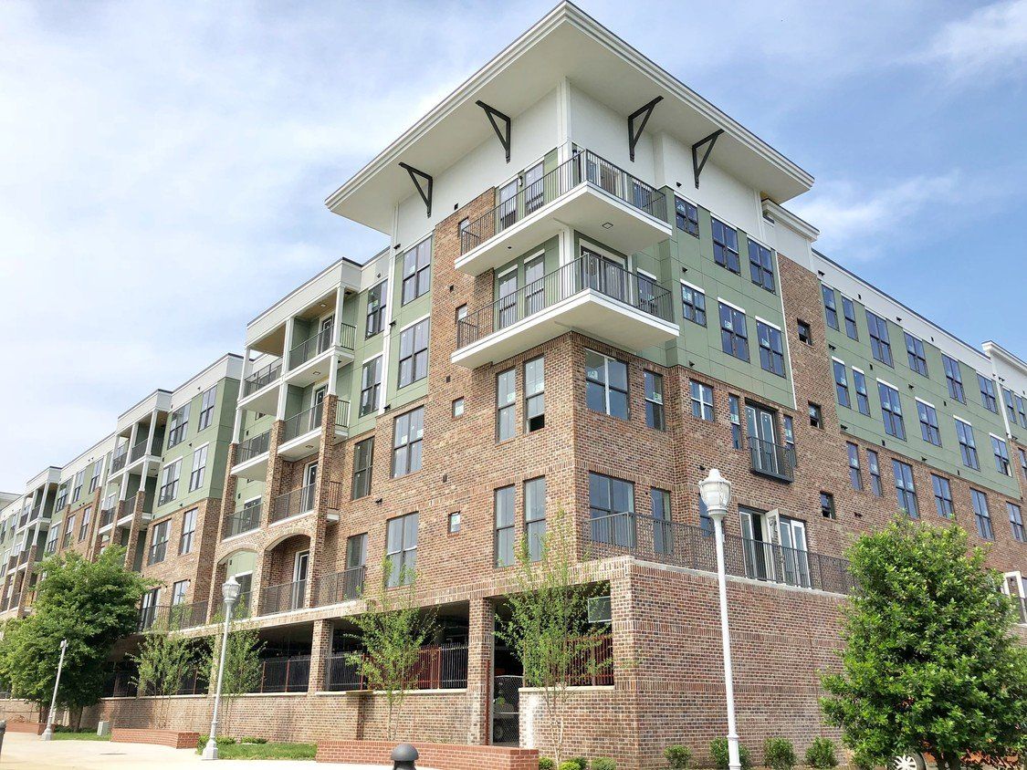 A large apartment building with a lot of windows and balconies.