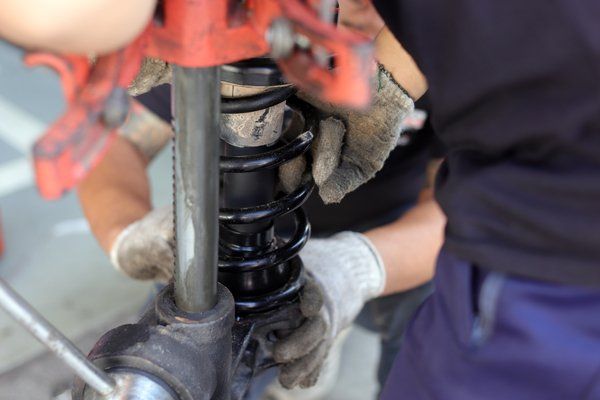 Professional mechanic doing suspension repair — Valley City, ND — Quality Alignment & Brake Center Professional mechanic doing suspension repair — Valley City, ND — Quality Alignment & Brake Center