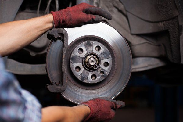 Mechanic doing brake repairs — Valley City, ND — Quality Alignment & Brake Center Mechanic doing brake repairs — Valley City, ND — Quality Alignment & Brake Center