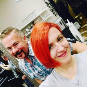 Woman with Orange Hair and Smiling Man at the Back — Scottsdale, AZ — XanderLyn Salon