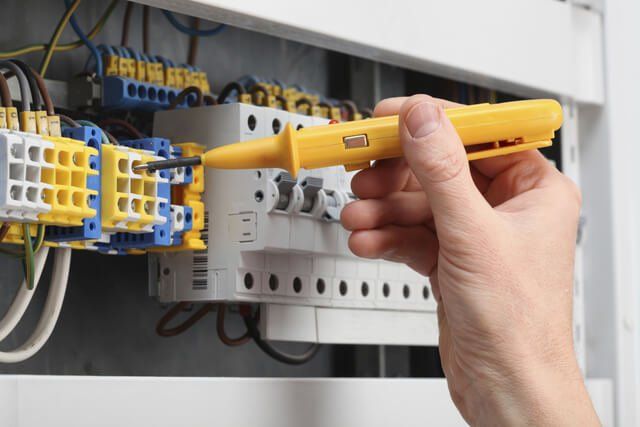 commercial electrician fixing breaker