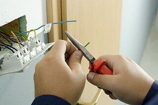 commercial electrician cutting wire
