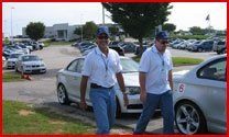 Car Shop — Staff Of Sam's Automotive With  Cars Behind Them In Jacksonville, FL