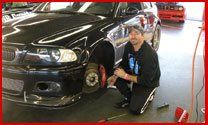 Transmission Problems — Man Repairing A Car Besides Him  In Jacksonville, FL