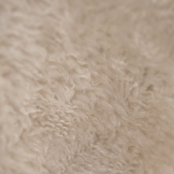 Close-up of beige fuzzy fabric texture